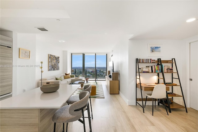 121 NE 34th St Unit 2412, Miami, FL 33137 - dining space featuring floor to ceiling windows, light wood-type flooring, a desk, recessed lighting, and baseboards