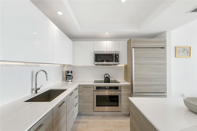 121 NE 34th St Unit 2412, Miami, FL 33137 - kitchen with stainless steel appliances, modern cabinets, a sink, recessed lighting, and light countertops