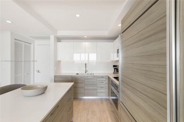 121 NE 34th St Unit 2412, Miami, FL 33137 - kitchen featuring a sink, modern cabinets, oven, light countertops, and recessed lighting