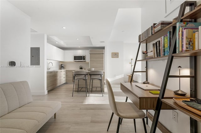 121 NE 34th St Unit 2412, Miami, FL 33137 - office space featuring electric panel, baseboards, recessed lighting, a sink, and light wood-style floors