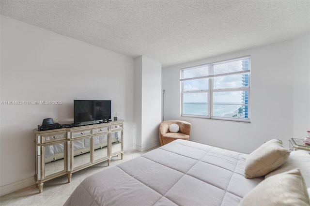 1950 S Ocean Dr Unit 18Q, Hallandale Beach, FL 33009 - bedroom with light tile patterned floors, a textured ceiling, and baseboards