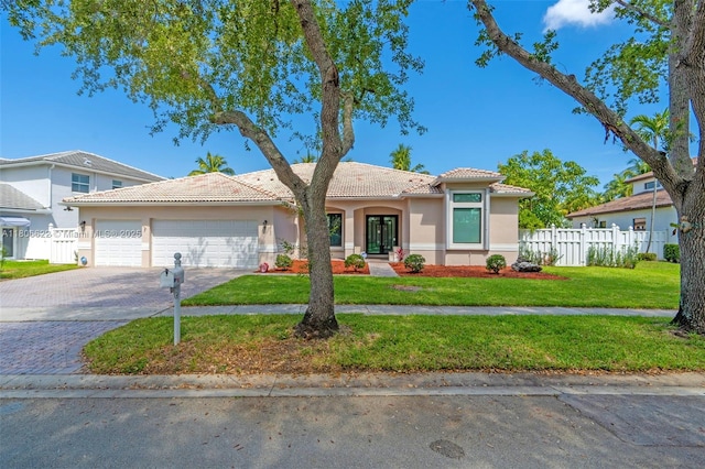 3560 SW 145th Ave, Miramar, FL 33027 - mediterranean / spanish home featuring stucco siding, a tiled roof, a garage, driveway, and french doors