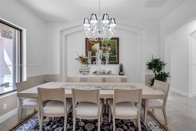 3560 SW 145th Ave, Miramar, FL 33027 - dining room with a chandelier, baseboards, and arched walkways