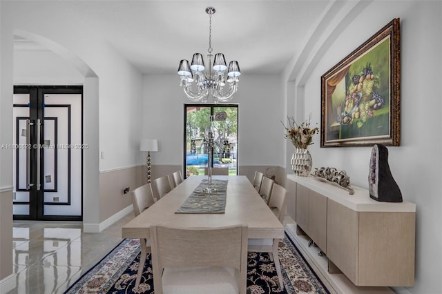 3560 SW 145th Ave, Miramar, FL 33027 - dining area with arched walkways, a chandelier, and baseboards