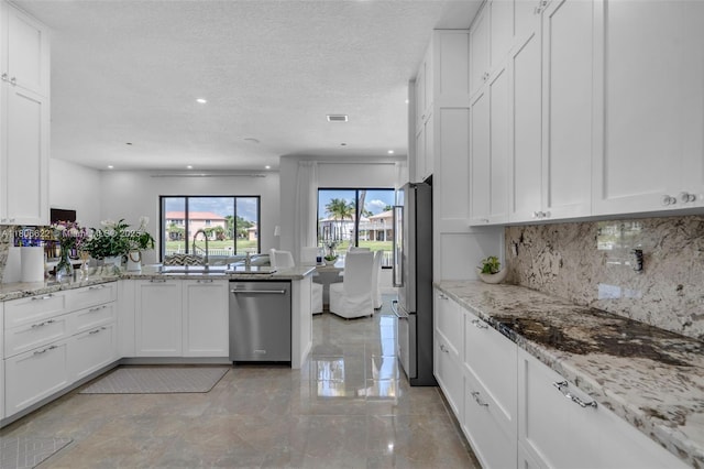 3560 SW 145th Ave, Miramar, FL 33027 - kitchen featuring stainless steel appliances, a sink, a peninsula, white cabinetry, and recessed lighting