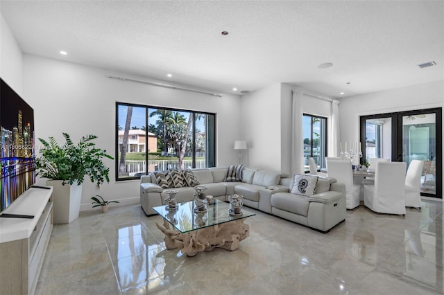 3560 SW 145th Ave, Miramar, FL 33027 - living room with light marble finish flooring, recessed lighting, a textured ceiling, and baseboards