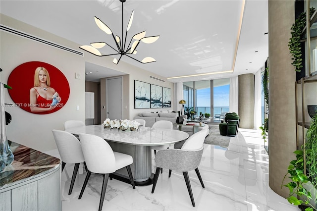 15701 Collins Ave Unit 705, Sunny Isles Beach, FL 33160 - dining area with a chandelier, expansive windows, light marble finish flooring, and a water view