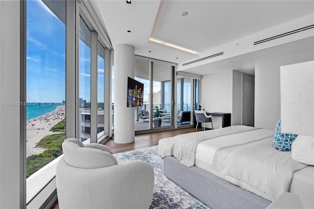 15701 Collins Ave Unit 705, Sunny Isles Beach, FL 33160 - bedroom featuring access to exterior, a wall of windows, and wood finished floors