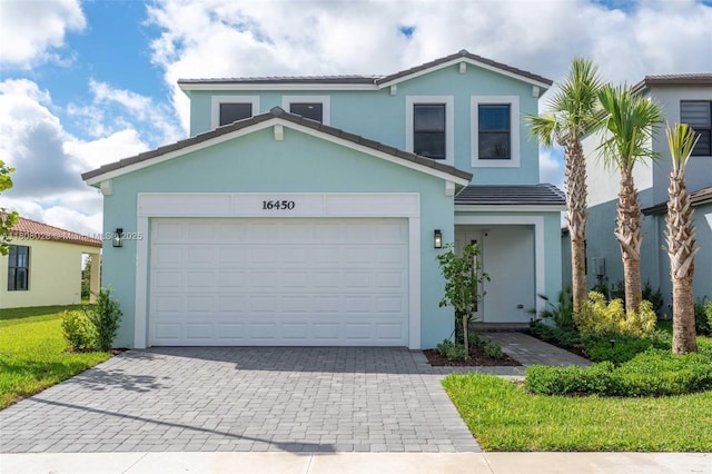 16450 Sea Turtle Pl, Loxahatchee, FL 33470 - traditional home with decorative driveway, stucco siding, a garage, and a tiled roof