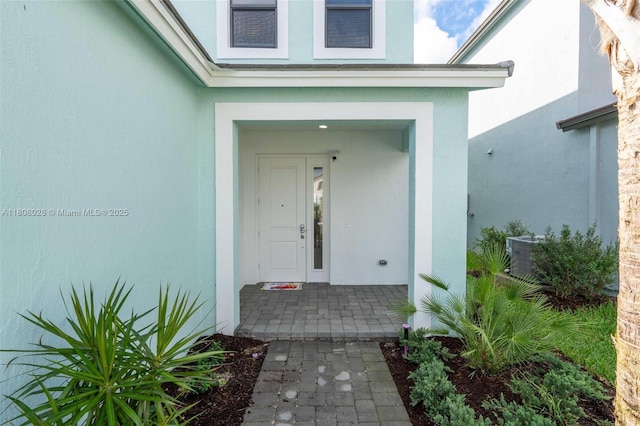 16450 Sea Turtle Pl, Loxahatchee, FL 33470 - property entrance with stucco siding and central AC