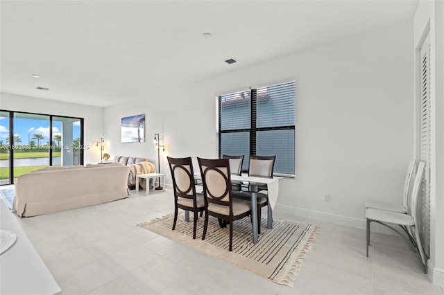 16450 Sea Turtle Pl, Loxahatchee, FL 33470 - dining room featuring a water view, baseboards, and light tile patterned floors