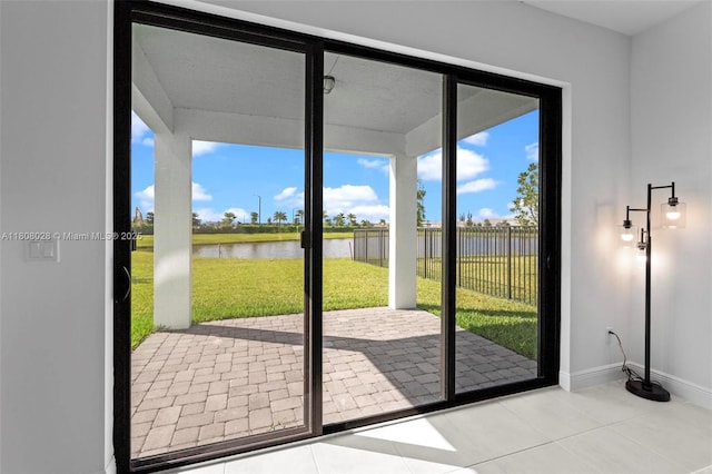 16450 Sea Turtle Pl, Loxahatchee, FL 33470 - doorway with a water view, baseboards, and tile patterned floors