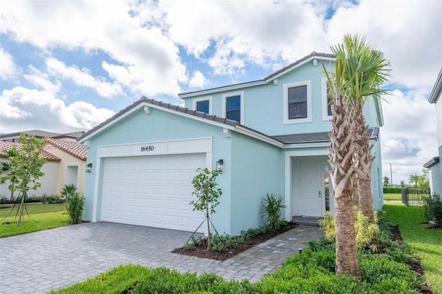 16450 Sea Turtle Pl, Loxahatchee, FL 33470 - traditional-style house with stucco siding, an attached garage, decorative driveway, and a tile roof