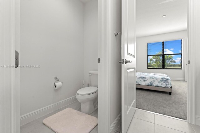 16450 Sea Turtle Pl, Loxahatchee, FL 33470 - bathroom featuring tile patterned floors, toilet, and baseboards