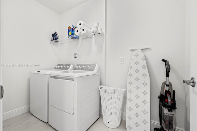 16450 Sea Turtle Pl, Loxahatchee, FL 33470 - washroom featuring washing machine and clothes dryer and baseboards