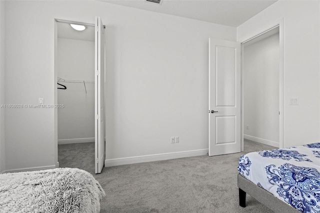 16450 Sea Turtle Pl, Loxahatchee, FL 33470 - carpeted bedroom featuring a walk in closet, a closet, and baseboards