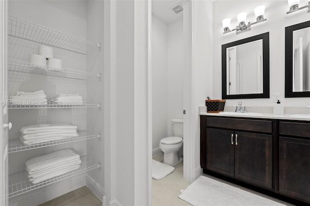 16450 Sea Turtle Pl, Loxahatchee, FL 33470 - bathroom with vanity, toilet, baseboards, and tile patterned flooring