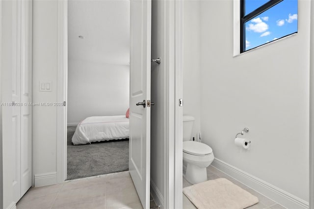 16450 Sea Turtle Pl, Loxahatchee, FL 33470 - ensuite bathroom featuring baseboards, toilet, and tile patterned flooring