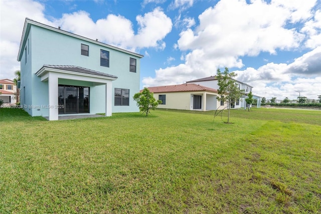 16450 Sea Turtle Pl, Loxahatchee, FL 33470 - rear view of house with stucco siding and a lawn