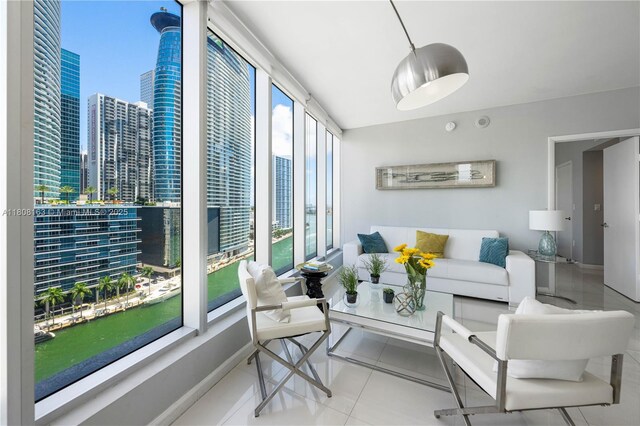 485 Brickell Ave Unit 1604, Miami, FL 33131 - dining space featuring a chandelier, light tile patterned flooring, and baseboards