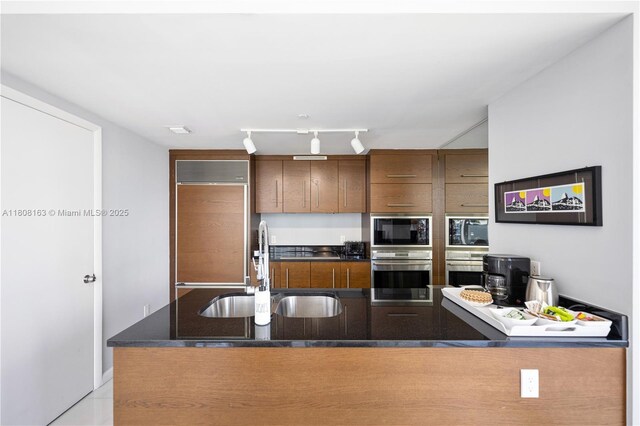 485 Brickell Ave Unit 1604, Miami, FL 33131 - kitchen with modern cabinets, a sink, a wall of windows, a chandelier, and a view of city