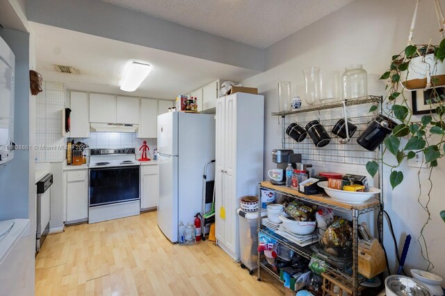 6870 SW 45th Ln Unit 8, Miami, FL 33155 - kitchen featuring white appliances, under cabinet range hood, backsplash, white cabinets, and light wood-type flooring