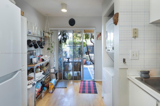 6870 SW 45th Ln Unit 8, Miami, FL 33155 - washroom featuring wood finished floors and estacked washer and dryer
