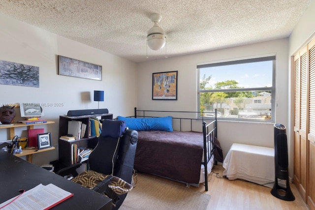 6870 SW 45th Ln Unit 8, Miami, FL 33155 - bedroom with wood finished floors, multiple windows, a closet, a desk, and a textured ceiling