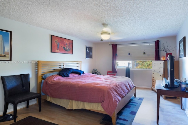 6870 SW 45th Ln Unit 8, Miami, FL 33155 - bedroom featuring wood finished floors, a textured ceiling, and ceiling fan