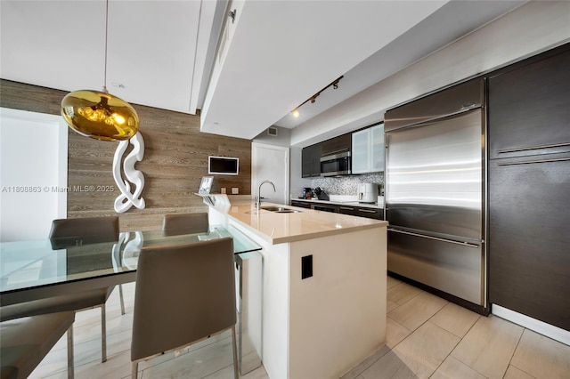 55 SE 6th St Unit 2803, Miami, FL 33131 - kitchen with stainless steel appliances, a sink, tasteful backsplash, track lighting, and a peninsula