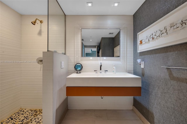 55 SE 6th St Unit 2803, Miami, FL 33131 - bathroom with tile walls, a tile shower, vanity, and tile patterned floors