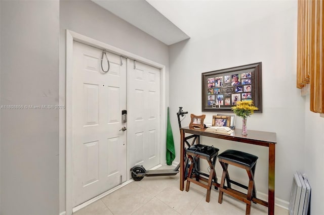 21519 SW 90th Ave, Cutler Bay, FL 33189 - foyer entrance with light tile patterned floors, baseboards, and radiator heating unit