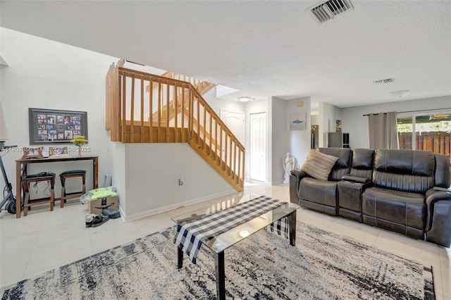 21519 SW 90th Ave, Cutler Bay, FL 33189 - tiled living room featuring stairway, a textured ceiling, and baseboards