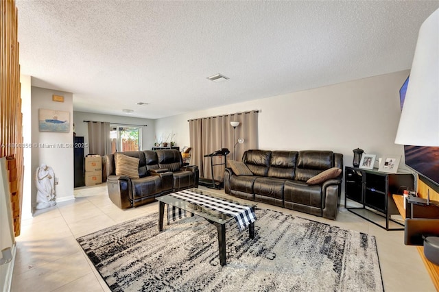 21519 SW 90th Ave, Cutler Bay, FL 33189 - living area featuring a textured ceiling and light tile patterned floors