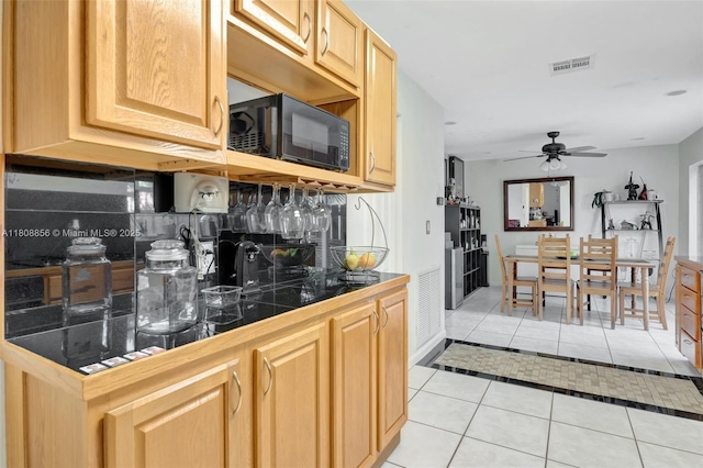 21519 SW 90th Ave, Cutler Bay, FL 33189 - kitchen with black microwave, light tile patterned floors, tasteful backsplash, light brown cabinets, and a ceiling fan