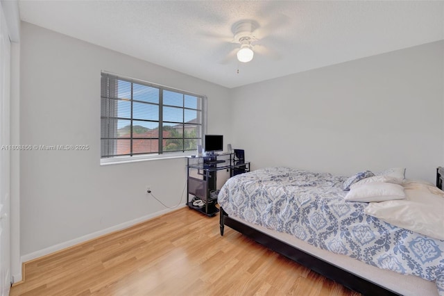 21519 SW 90th Ave, Cutler Bay, FL 33189 - bedroom with wood finished floors, baseboards, and a ceiling fan
