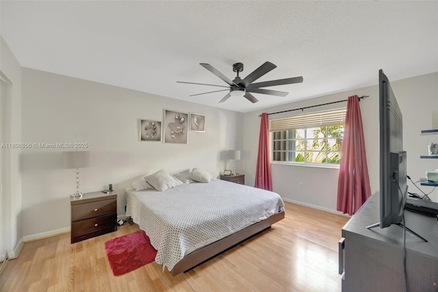 21519 SW 90th Ave, Cutler Bay, FL 33189 - bedroom featuring baseboards, light wood-type flooring, and a ceiling fan