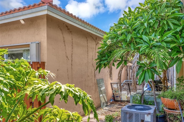 21519 SW 90th Ave, Cutler Bay, FL 33189 - view of property exterior with central AC, stucco siding, and a tile roof