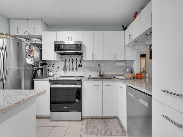 367 S Federal Hwy Unit B206, Deerfield Beach, FL 33441 - kitchen featuring stainless steel appliances, a sink, light tile patterned floors, and tasteful backsplash