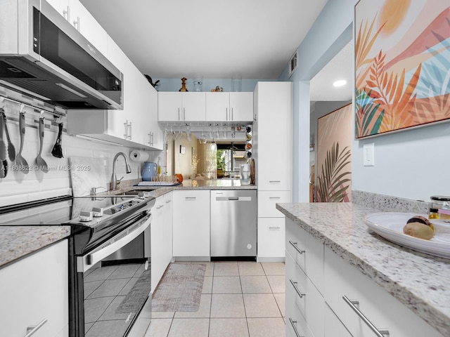 367 S Federal Hwy Unit B206, Deerfield Beach, FL 33441 - kitchen featuring appliances with stainless steel finishes, a sink, white cabinets, light tile patterned flooring, and recessed lighting
