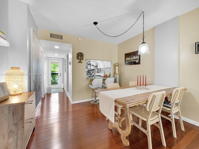 367 S Federal Hwy Unit B206, Deerfield Beach, FL 33441 - dining area with dark wood-style floors, baseboards, and a textured ceiling