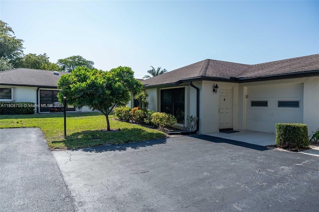 10198 Dovewood Ln Unit A, Boynton Beach, FL 33436 - ranch-style home with stucco siding, a front yard, and driveway