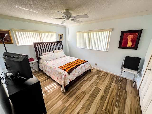 10198 Dovewood Ln Unit A, Boynton Beach, FL 33436 - bedroom with ornamental molding, a textured ceiling, wood finished floors, ceiling fan, and baseboards