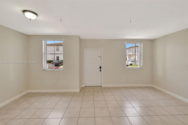 8199 W 36th Ave Unit 5, Hialeah, FL 33018 - empty room featuring baseboards and light tile patterned floors