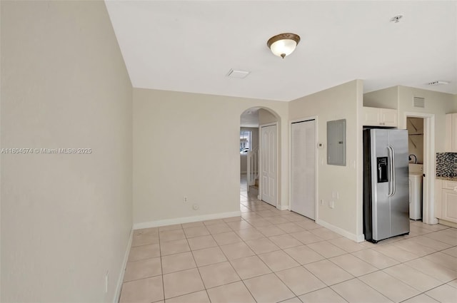 8199 W 36th Ave Unit 5, Hialeah, FL 33018 - unfurnished room with arched walkways, electric panel, baseboards, light tile patterned flooring, and a pendent fire sprinkler
