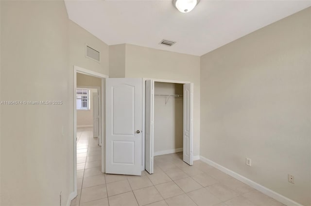 8199 W 36th Ave Unit 5, Hialeah, FL 33018 - unfurnished bedroom featuring light tile patterned floors, baseboards, and a closet