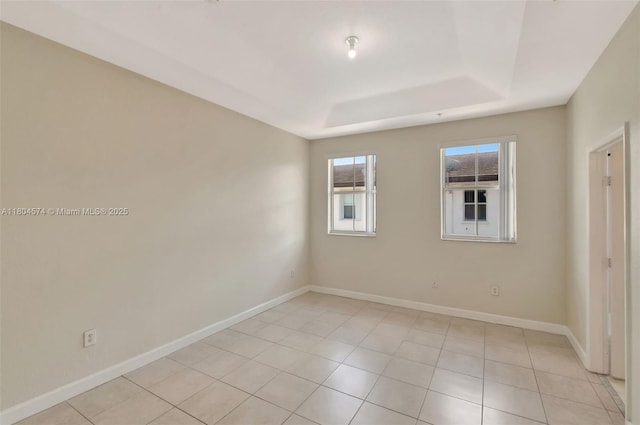 8199 W 36th Ave Unit 5, Hialeah, FL 33018 - unfurnished room featuring a tray ceiling, baseboards, and light tile patterned flooring