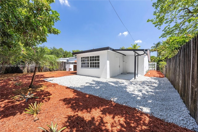 3420 SW 12th Pl, Fort Lauderdale, FL 33312 - rear view of house featuring stucco siding and a fenced backyard