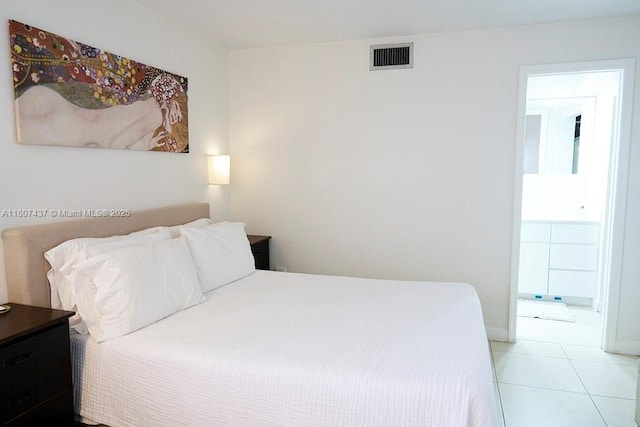 20105 NE 3rd Ct Unit 9, Miami, FL 33179 - bedroom featuring light tile patterned floors, ensuite bathroom, and baseboards