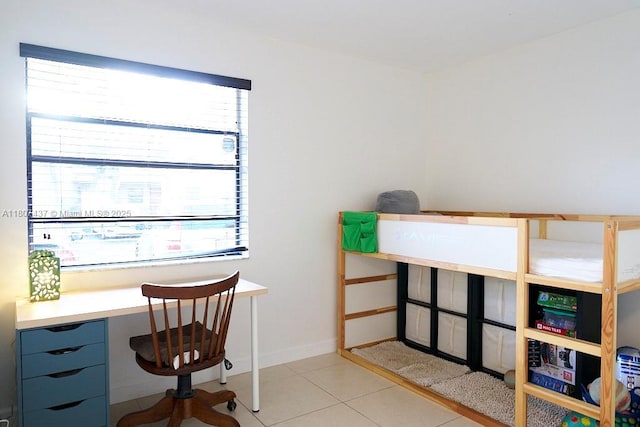 20105 NE 3rd Ct Unit 9, Miami, FL 33179 - bedroom with light tile patterned flooring and a desk